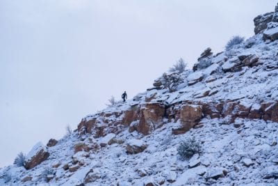 A trail runner climbs the snow covered Curt’s Lane trail in the Lunch Loops.